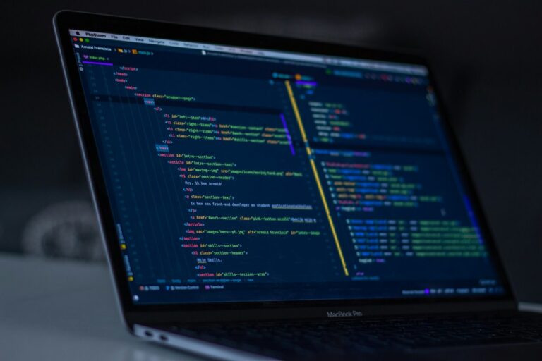 Software engineer programming autonomous AI agent logic and API tooling on dual monitors