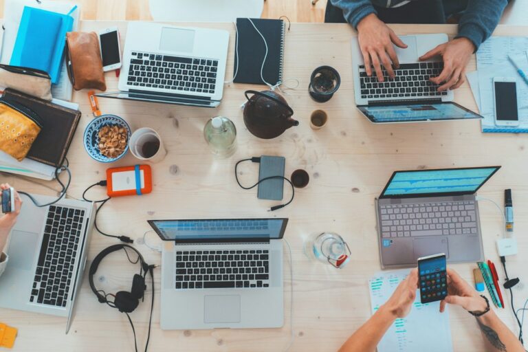 Remote entrepreneur managing profitable online AI businesses on laptop