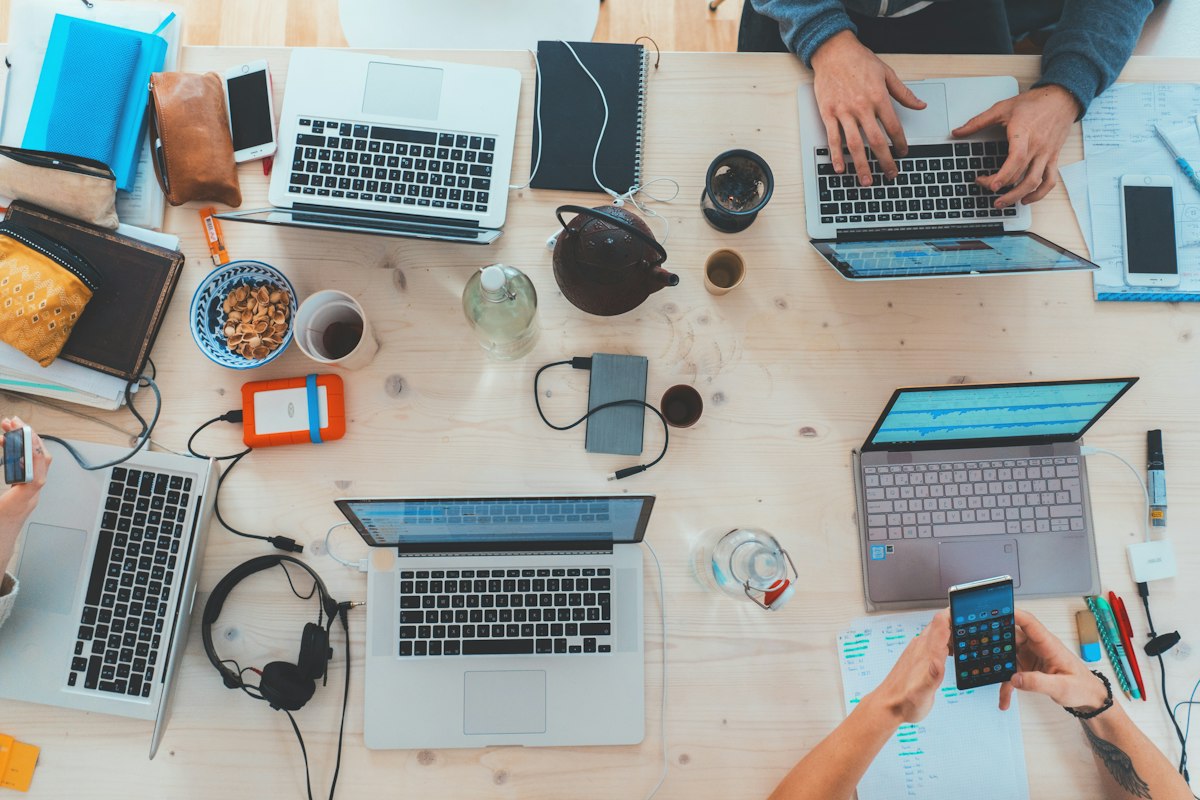 Remote entrepreneur managing profitable online AI businesses on laptop