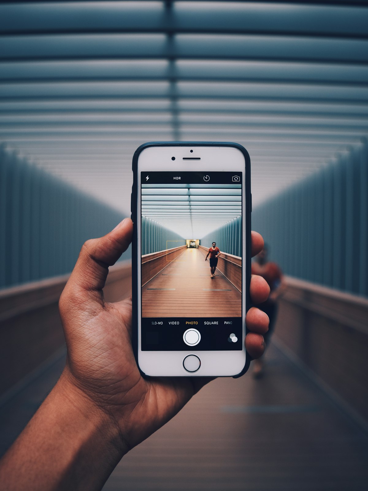 Hands holding modern Android smartphone testing smart assistant applications